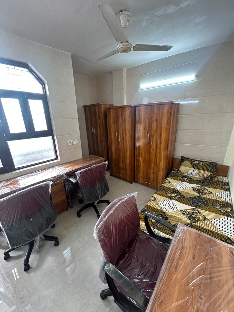 Spacious furnished room with wardrobe and desk